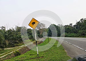 Traffic road sign alerting wild life, driving in Malaysia