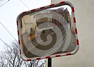 Traffic safety mirror with reflection of  old street, Krakow, Poland