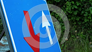 Traffic sign. blue square with red and white arrows. Road works sign. close-up. Repair work is underway on the road