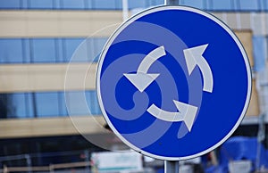 Traffic sign circulation site, white arrows on blue background
