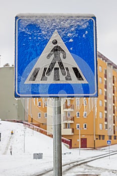 Traffic sign covered by ice and snow