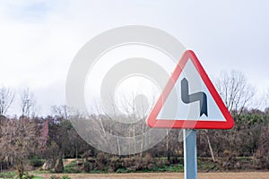 Traffic sign of dangerous curves on county road
