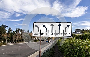 Traffic Sign with five arrows for different directions against a blue sky