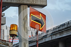 Traffic sign with flags reading utilitary. Electronic arrow pointing to the right to divert traffic photo
