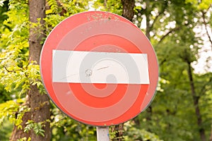 Traffic sign forbidden stop on forest road with trees