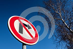 The traffic sign forbidding to turn right against blue sky