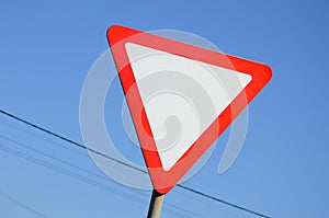 Traffic sign in the form of a white triangle. Give way