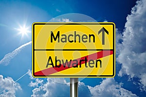 Traffic sign with the german words for Do and wait - Machen und abwarten photo