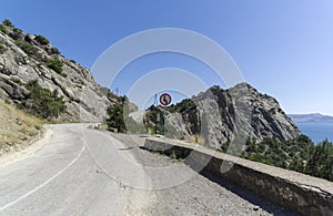 Traffic sign `Give way on oncoming traffic` in fron of the pass on the mountain road.