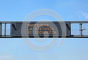 Traffic sign in high with text that means keep the safety distan photo