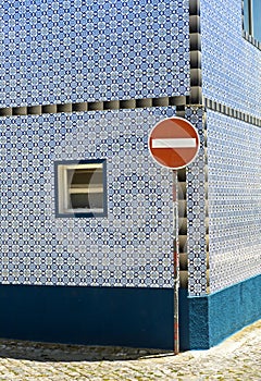 Traffic sign No entry for vehicular traffic in front of a residential building