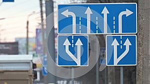 Traffic sign pointing multiple road lanes direction on city street. Signboard arrows for urban transport safety guidance