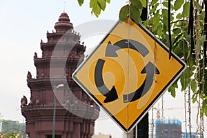 Traffic sign of roundabout and The Independence Monument, memorial Cambodian Independence Day after winning from the French