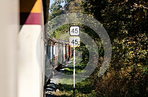 The traffic sign shows the train`s limited speed, climbing to the high mountain with the diesel-electric locomotive