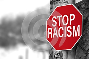Traffic sign with `Stop racism` message. Selective focus.