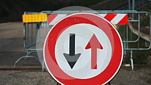 Traffic sign. Symbol. reverse movement. close-up. red and black arrows in a round red frame sign. Repair work is