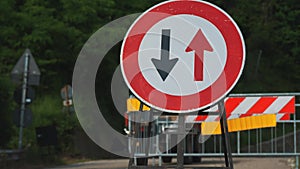 Traffic sign. Symbol. reverse movement. close-up. red and black arrows in a round red frame sign. Repair work is