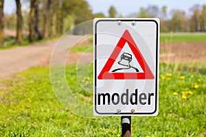 Traffic sign with text Modder or Mud along road