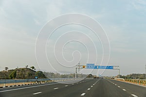 Traffic signs along the Delhi-Mumbai Expressway in India on a sunny day