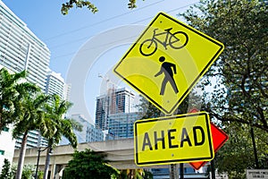 Traffic signs on city road in miami, usa. Bicycle and pedestrian crossing ahead warning. Transportation traffic and travel. Cautio