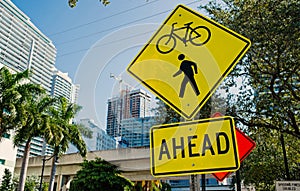 Traffic signs on city road in miami, usa. Bicycle and pedestrian crossing ahead warning. Transportation traffic and