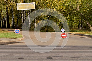 Traffic signs `entry is prohibited` and `stop is prohibited` at the entrance to the park