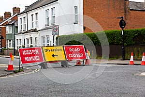 Traffic signs informing the public that the road is closed ahead and to follow the diversion