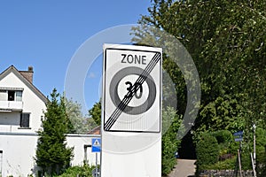 Traffic signs marking end of reduced speed zone of 30 km and end of residential district, in village Urdorf in Switzerland.