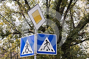 Traffic signs pedestrian crossing and main road