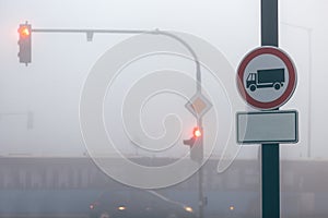 Traffic signs and road in smog