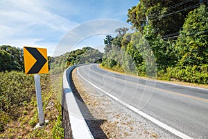 Traffic signs say the curve right direction on mountain highway, warning accident