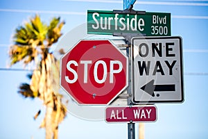 Traffic signs, stop all way and one way, and Surfside Blvd sign
