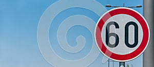 Traffic speed limit sign for restriction on 60 kilometers or miles per hour with blue sky background with copy space