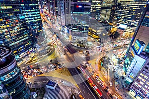 Traffic speeds through an intersection at night in Gangnam, Seoul in South Korea