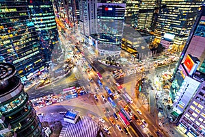 Traffic speeds through an intersection at night in Gangnam, Seoul in South Korea