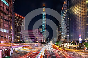 Traffic speeds through an intersection at night in Taiwan.