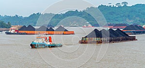 Traffic of tugboats dragging barge of coal at Mahakam river, Indonesia