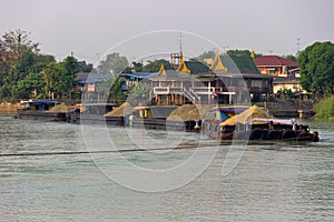 Traffic of vessels and boats on river, extraction of sand