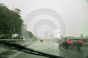 Traffic view of a rainy and gloomy day from inside of a car windshield