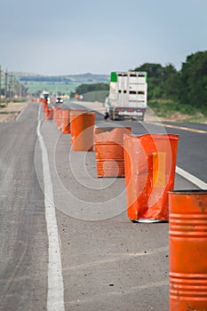 Traffic warning cones in row to separate route in road area