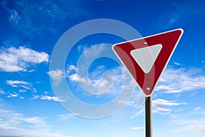 Traffic Yield Sign With Blue Sky Background photo