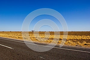 traight road in the dessert of Australia on the Flinders Hightway, Quennsland Australia