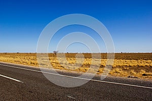 traight road in the dessert of Australia on the Flinders Hightway, Quennsland Australia photo