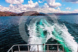 Trail  behind the boat on water surface , Lake Titicaca - the highest navigable Lake in the World. Peru