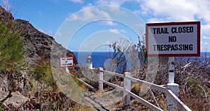 Trail closed sign along the Makapu`u Point hiking trail, eastern tip of Oahu, Hawaii.