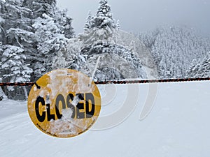 Trail is closed sign at winter snow day