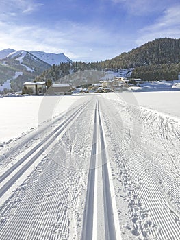 Trail for cross-country skiing with scenic winter snow landscape in Tirol in Achenkirch