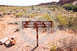 Trail direction sign for Pine Tree Arch and Tunnel Arch, part of the Devils Garden hiking trail in Arches National Park Utah