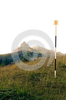 Trail direction sign with rocky mountains in the background