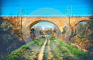 Trail foot path urban colour jog under straight bridge urban